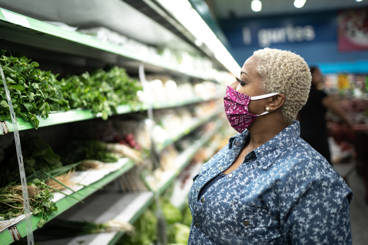 Woman in grocery store with fabric mask on
